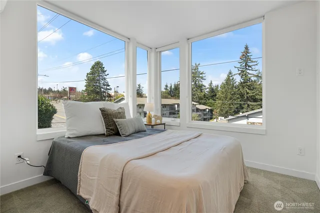 a bedroom with a large bed and a window