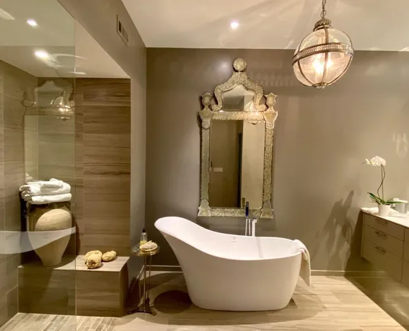 a bathroom with a tub sink and mirror