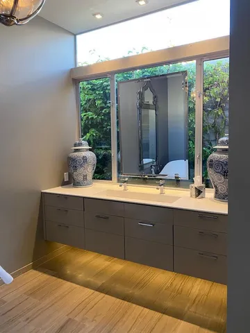 a bedroom with two beds and a chandelier