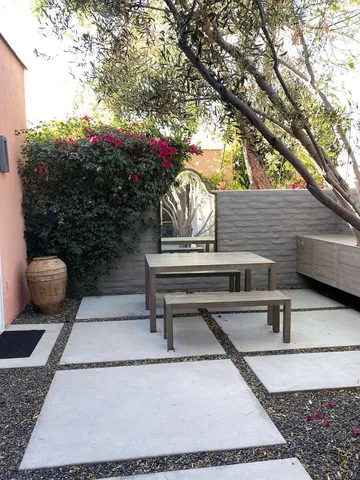 a view of a backyard with sitting area