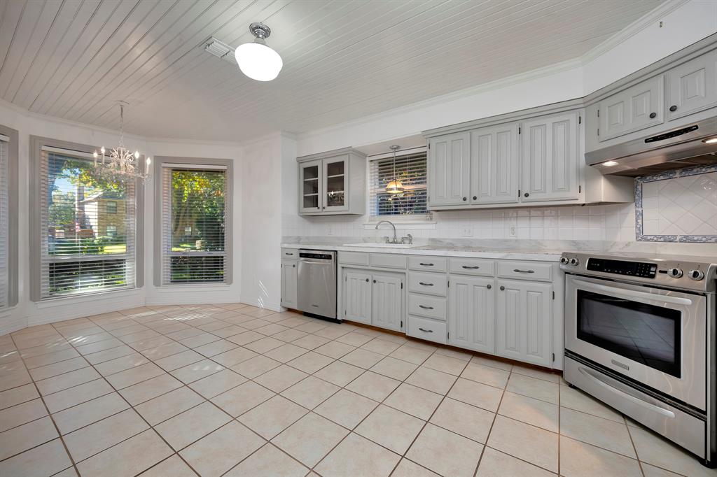 3409 Crescent Court Bedford, TX 76021 - Photo 12 of 40 a kitchen with a stove sink and cabinets