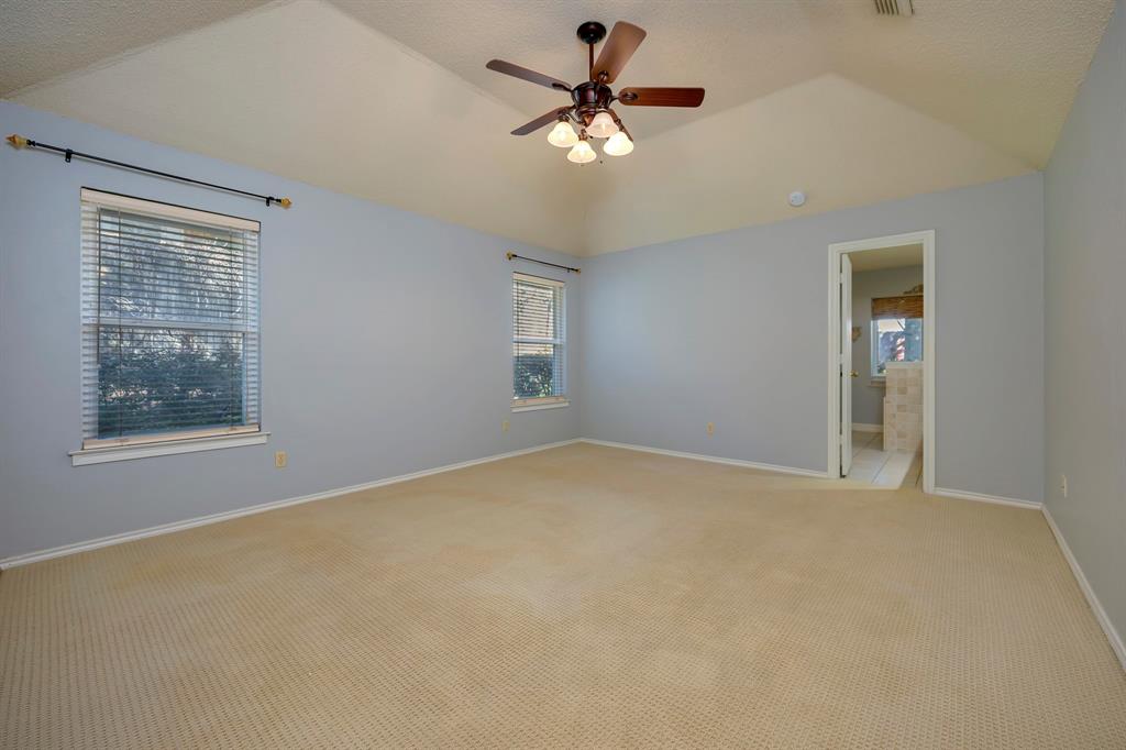 3409 Crescent Court Bedford, TX 76021 - Photo 16 of 40 a view of a room with a ceiling fan and a window