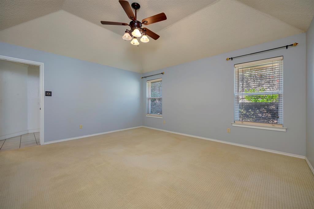 3409 Crescent Court Bedford, TX 76021 - Photo 17 of 40 an empty room with windows and fan