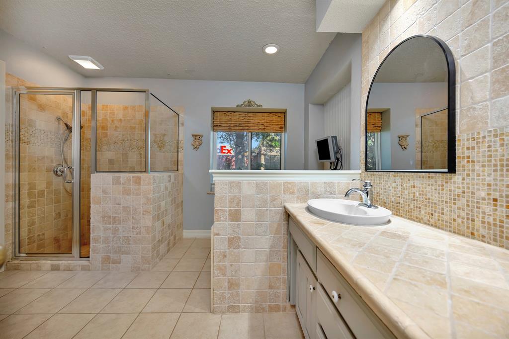 3409 Crescent Court Bedford, TX 76021 - Photo 20 of 40 a bathroom with a double vanity sink and a mirror