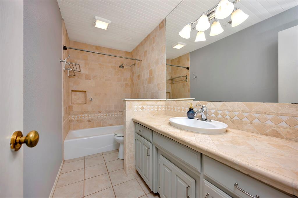 3409 Crescent Court Bedford, TX 76021 - Photo 27 of 40 a bathroom with a sink a tub and a mirror