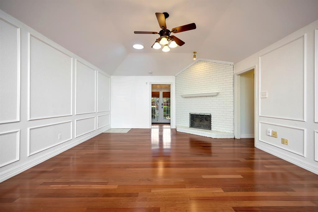 3409 Crescent Court Bedford, TX 76021 - Photo 3 of 40 a view of an empty room with wooden floor fireplace and a window