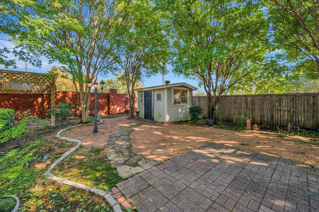 3409 Crescent Court Bedford, TX 76021 - Photo 34 of 40 a front view of a house with a yard and trees