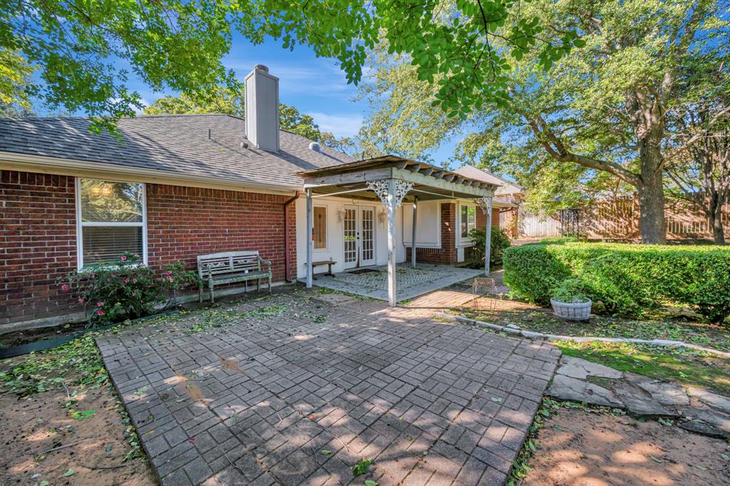 3409 Crescent Court Bedford, TX 76021 - Photo 35 of 40 a front view of a house with garden