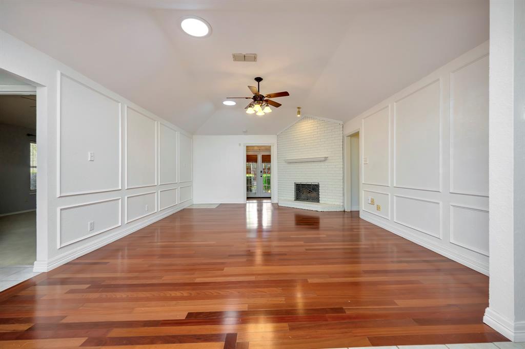 3409 Crescent Court Bedford, TX 76021 - Photo 4 of 40 a view of an empty room with wooden floor and a ceiling fan