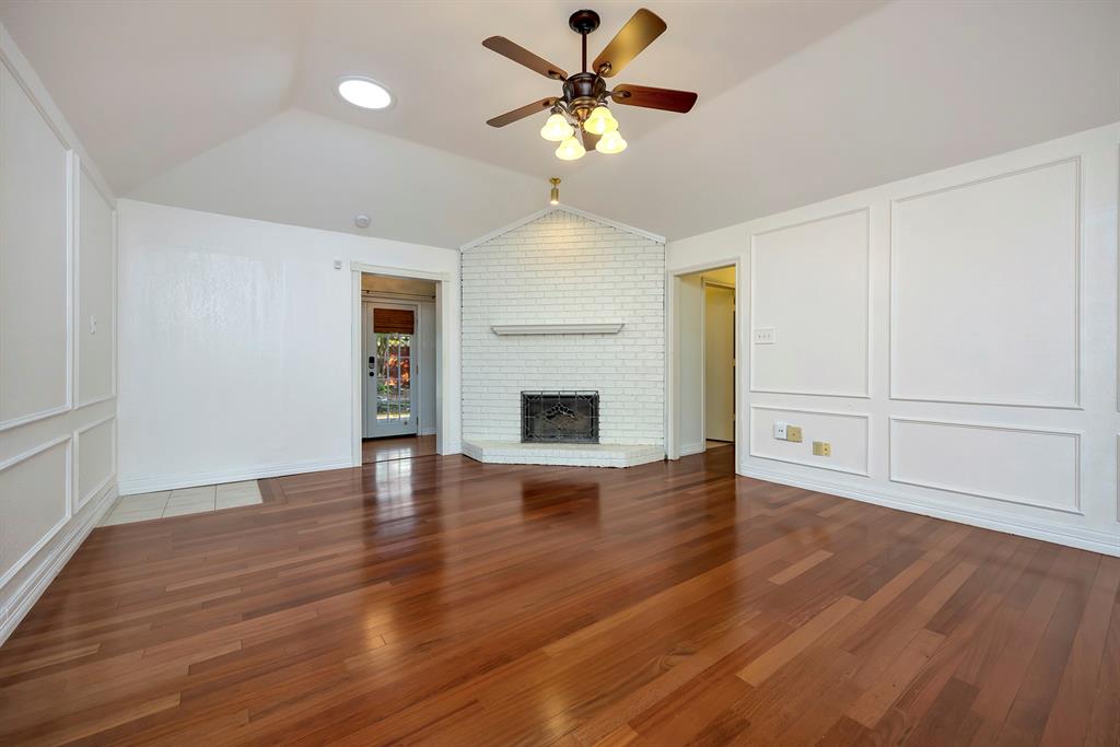 3409 Crescent Court Bedford, TX 76021 - Photo 5 of 40 a view of an empty room with wooden floor and a fireplace