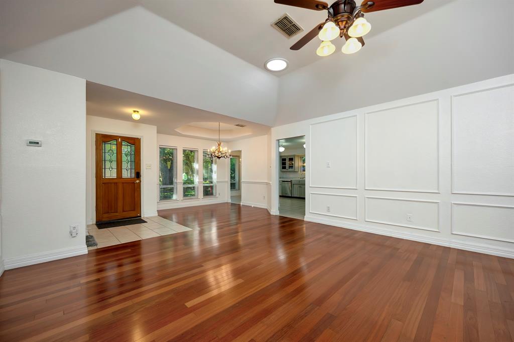 3409 Crescent Court Bedford, TX 76021 - Photo 9 of 40 a view of an empty room with wooden floor and a window
