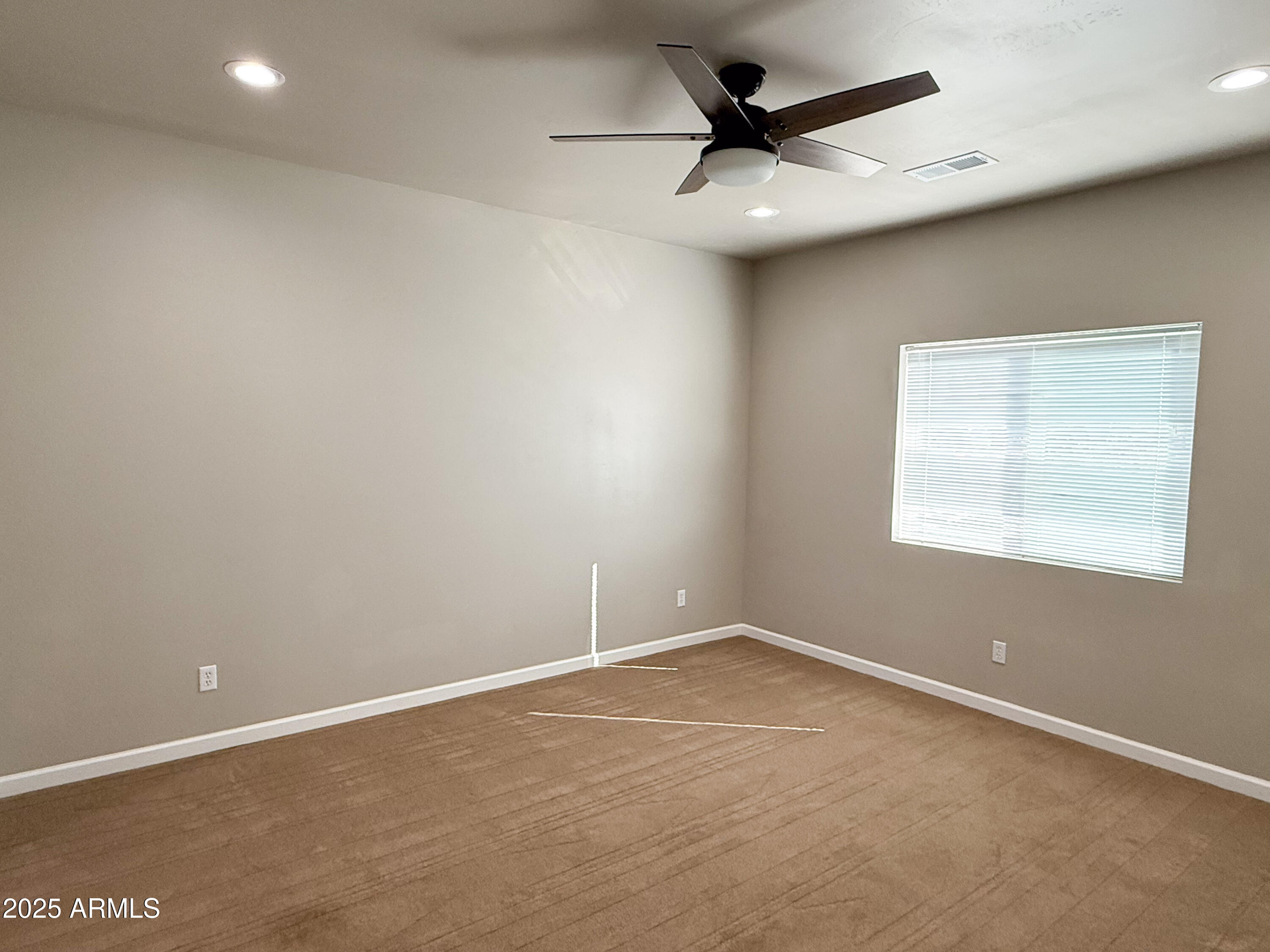 4850 East Oswego Street Rimrock, AZ 86335 - Photo 11 of 21 an empty room with a ceiling fan and window