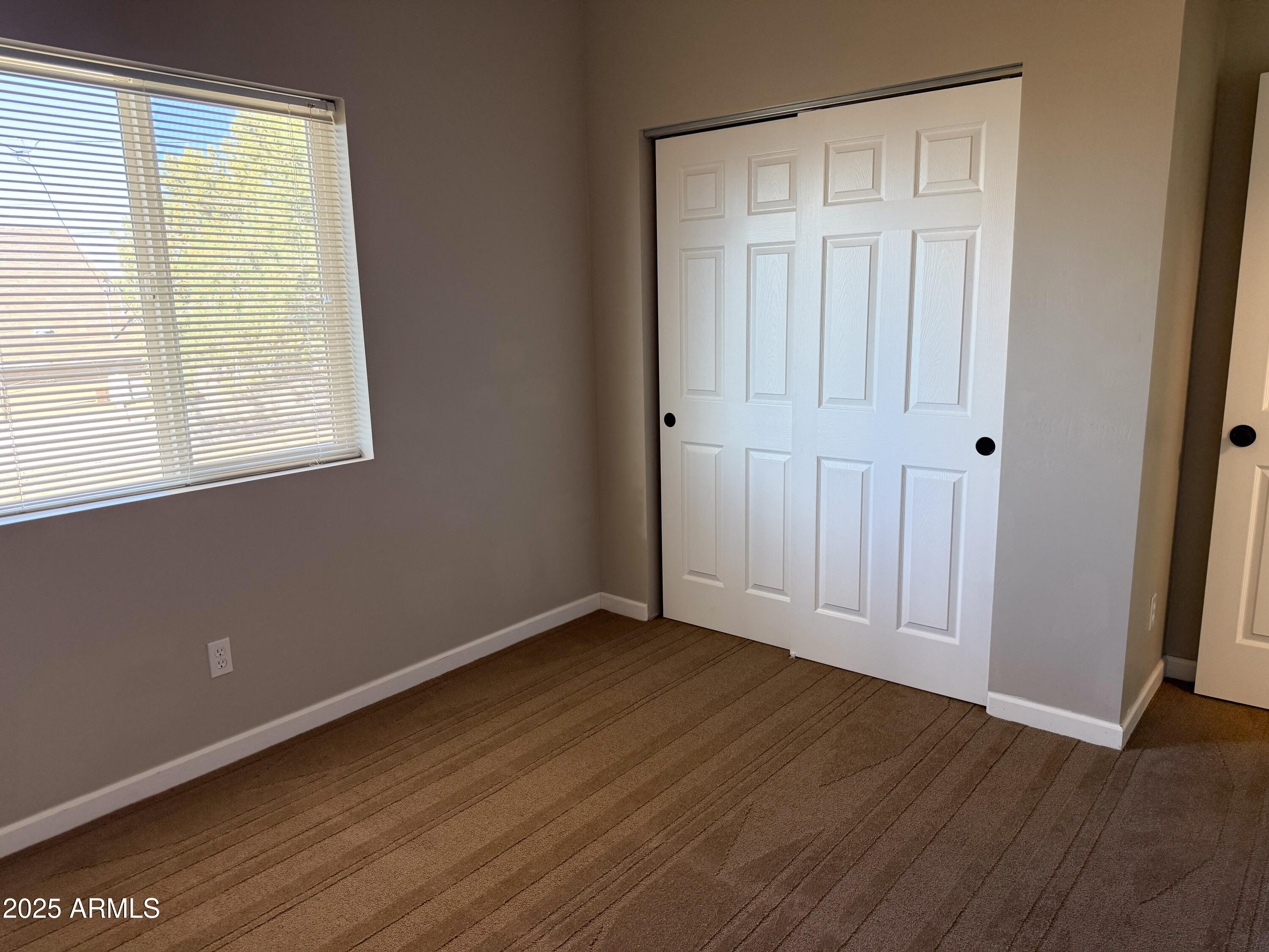 4850 East Oswego Street Rimrock, AZ 86335 - Photo 15 of 21 an empty room with wooden floor and windows