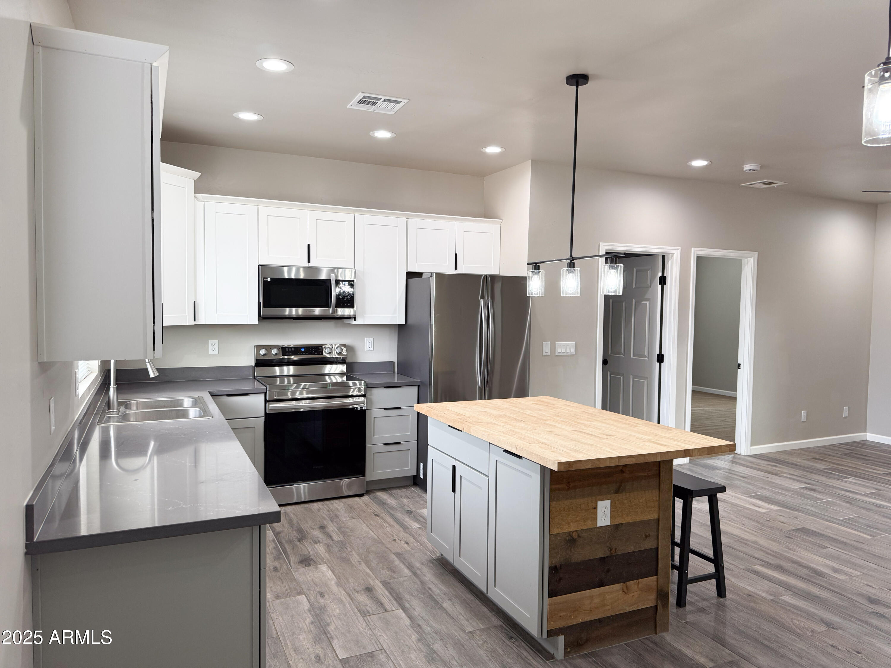 4850 East Oswego Street Rimrock, AZ 86335 - Photo 4 of 21 a kitchen with a refrigerator a sink dishwasher and a stove with wooden floor