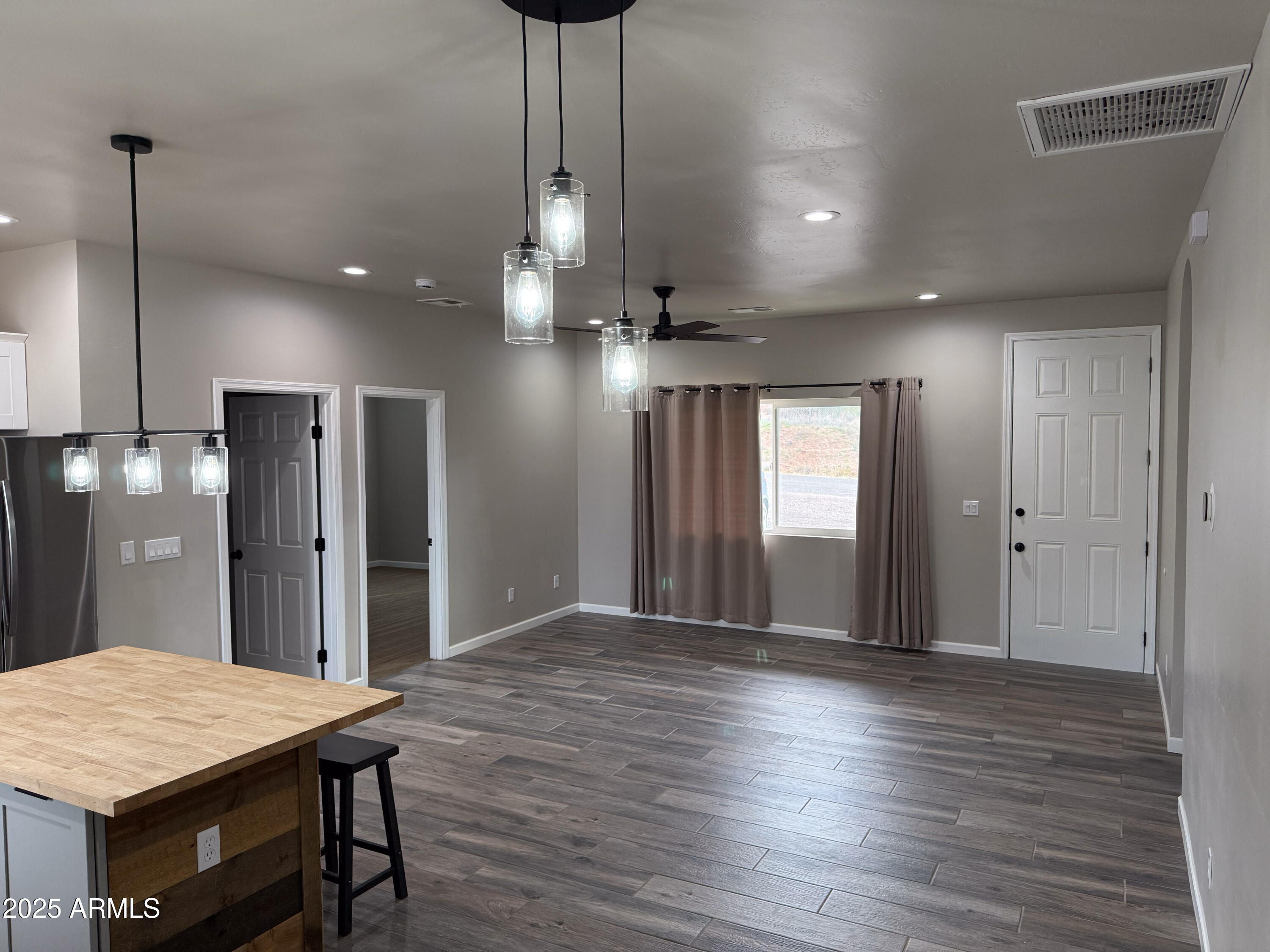 4850 East Oswego Street Rimrock, AZ 86335 - Photo 6 of 21 a large kitchen with stainless steel appliances granite countertop wooden floors wooden cabinets a center island and refrigerator