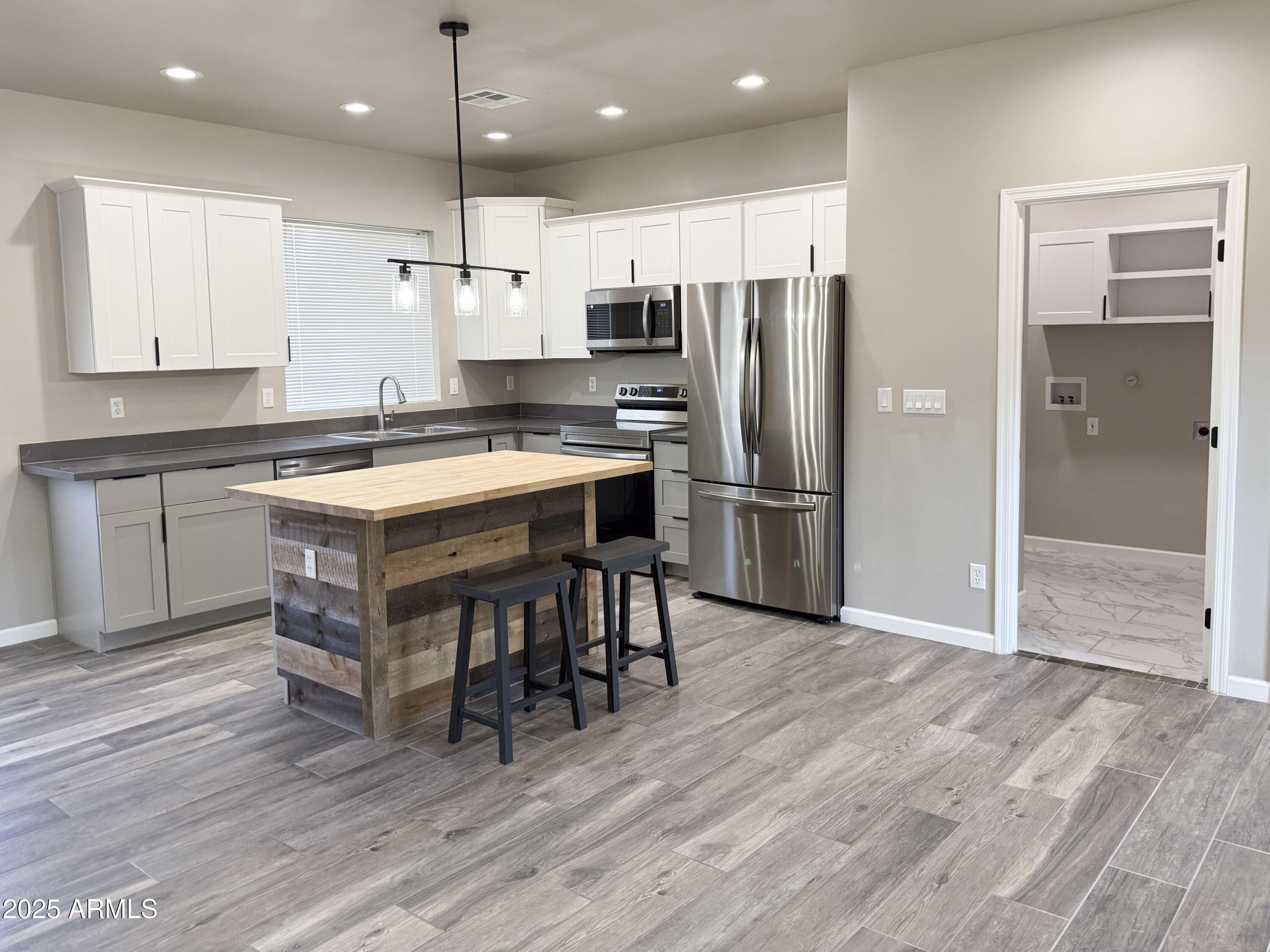 4850 East Oswego Street Rimrock, AZ 86335 - Photo 7 of 21 a kitchen with stainless steel appliances granite countertop a table chairs sink refrigerator and microwave