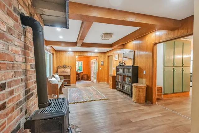 a view of a hallway with wooden floor and furniture