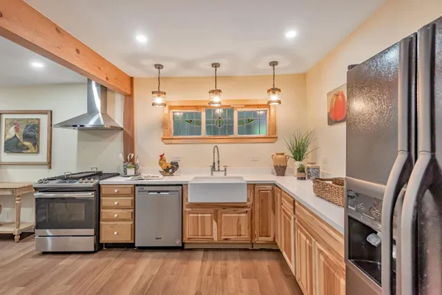 a kitchen with a sink stove and refrigerator