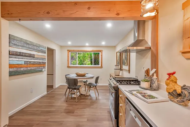 a dining room with furniture and wooden floor