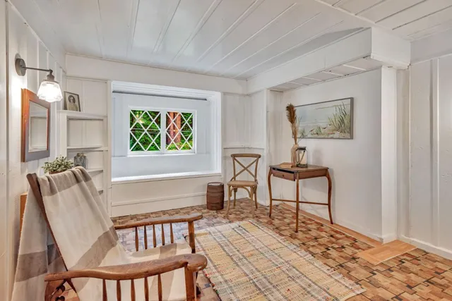 a view of a livingroom with furniture and a kitchen
