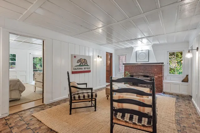 a bedroom with a large bed and windows