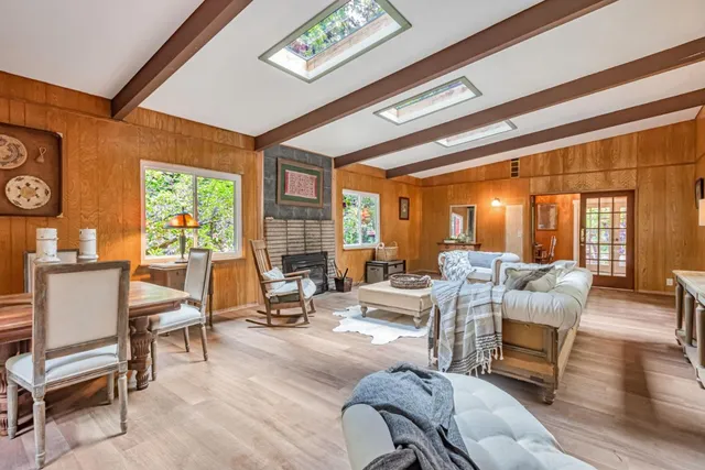 a living room with furniture and floor to ceiling windows