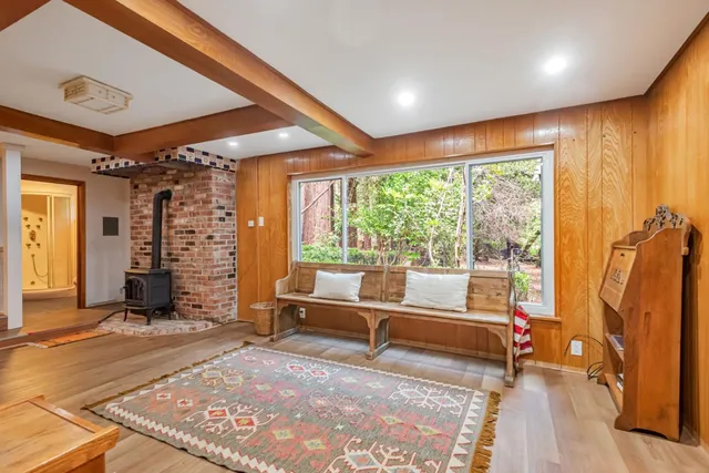 a living room with furniture and large windows