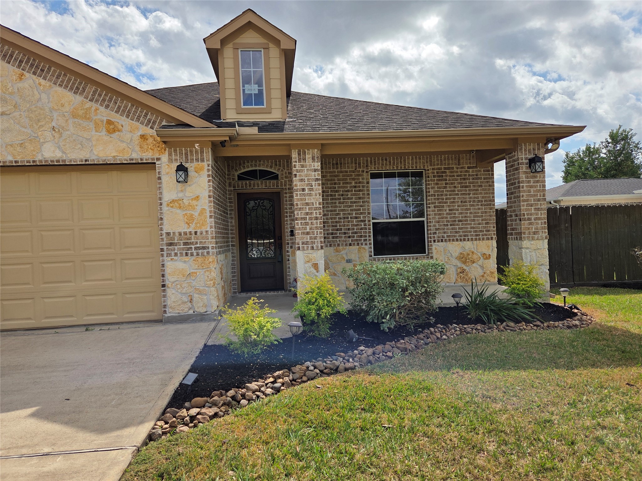 306 Masterson Street Arcola, TX 77583 - Photo 3 of 28 a front view of a house with garden