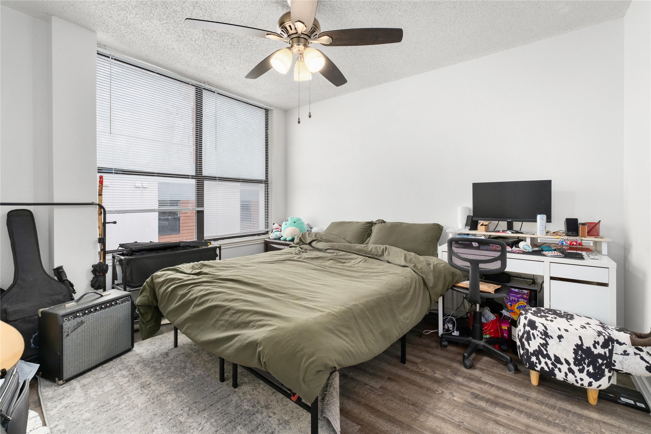 2409 Leon Street, Unit 307 Austin, TX 78705 - Photo 13 of 23 a bedroom with a bed and a chandelier