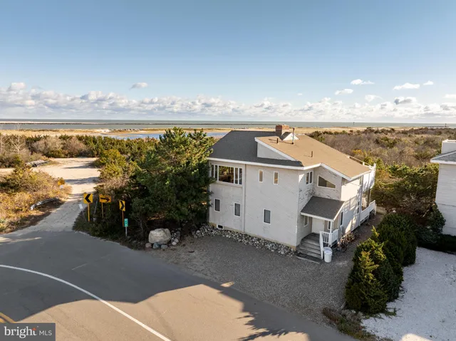 an aerial view of a house with a ocean view