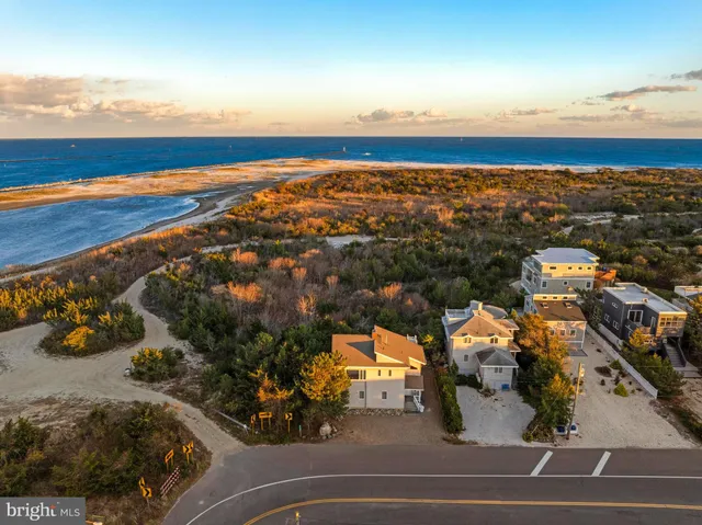 an aerial view of a building with outdoor space and ocean view