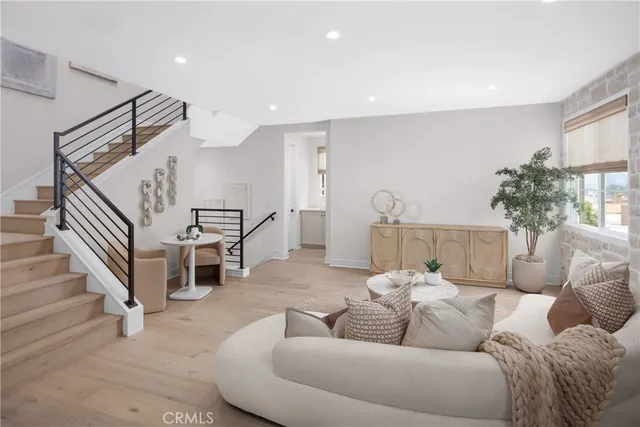 a living room with furniture and stairs