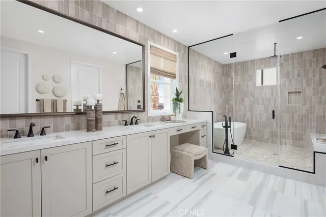 a spacious bathroom with a double vanity sink a mirror and a shower