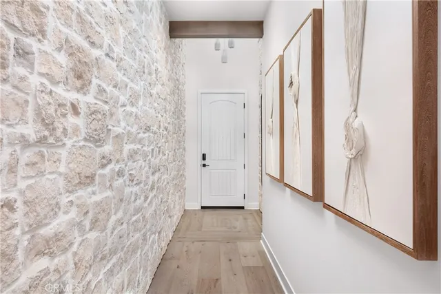 a view of a hallway with wooden floor and staircase