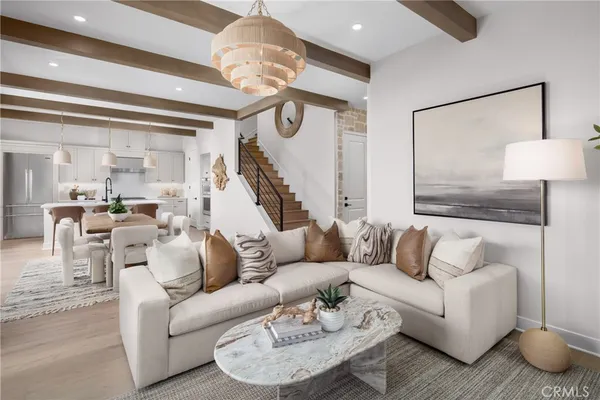 a living room with furniture and a chandelier