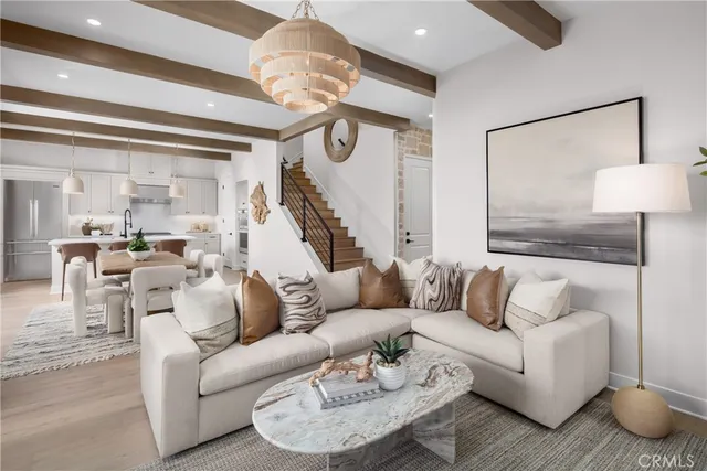 a living room with furniture and a chandelier