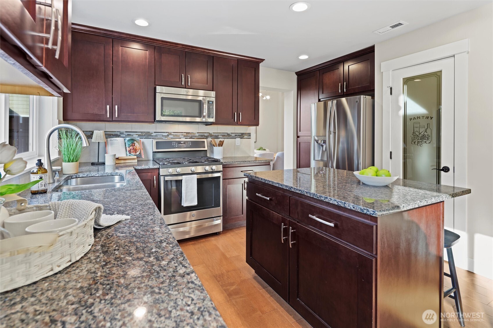 18927 10th Drive Southeast Bothell, WA 98012 - Photo 17 of 40 a kitchen with stainless steel appliances granite countertop a sink stove and refrigerator