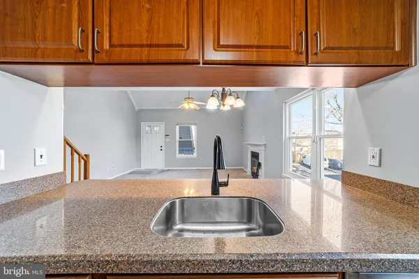 a kitchen with kitchen island granite countertop a sink