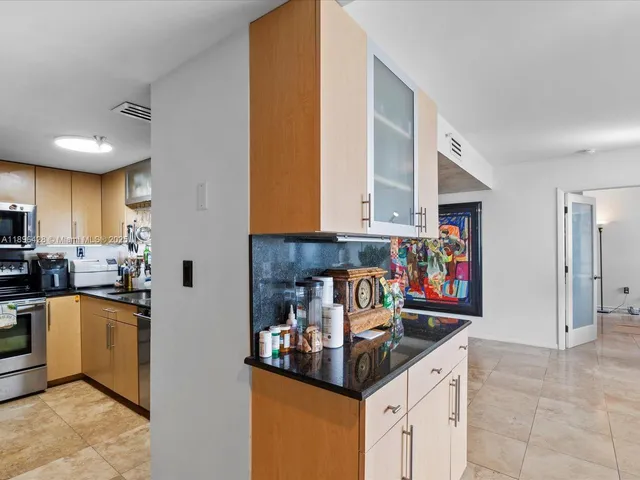 a kitchen with stainless steel appliances granite countertop a sink and cabinets