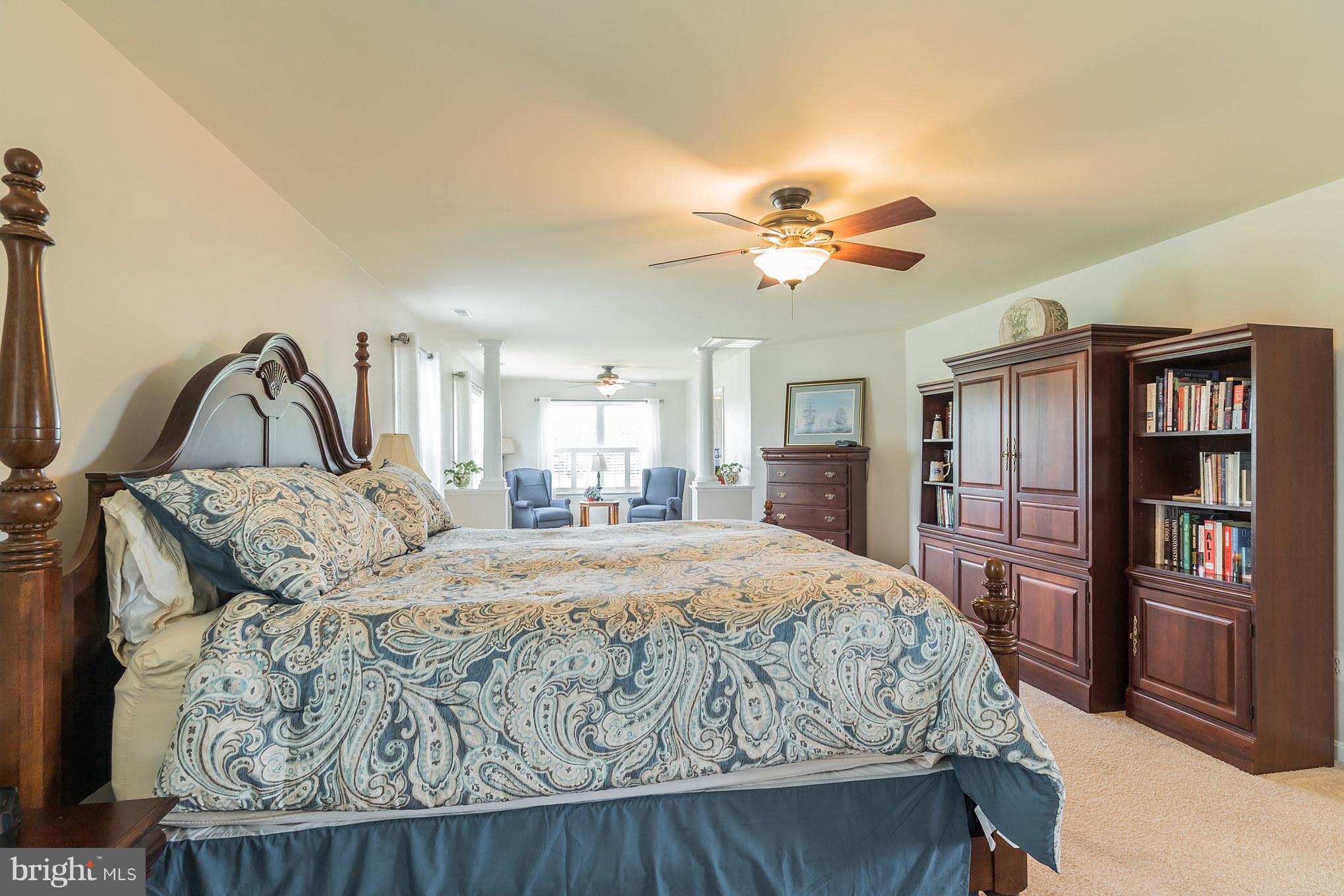 7420 Flint Hill Road Owings, MD 20736 - Photo 18 of 30 a bedroom with a large bed and a chandelier