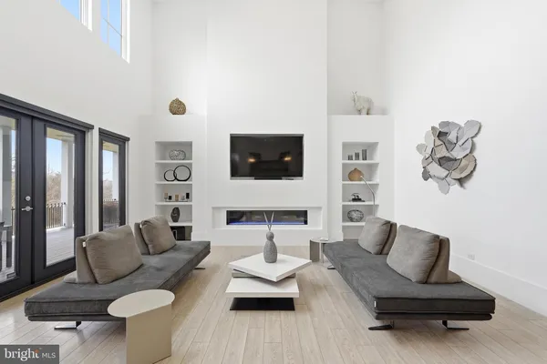 a living room with furniture a flat screen tv and a floor to ceiling window