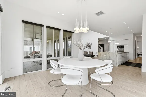 a dining room with furniture and a flat screen tv