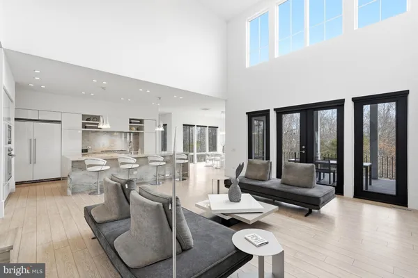 a living room with furniture and a flat screen tv with wooden floor