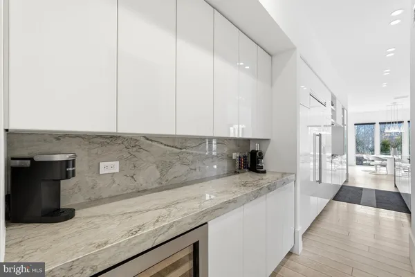 a view of a roof deck with table and chairs a barbeque with wooden floor and fence