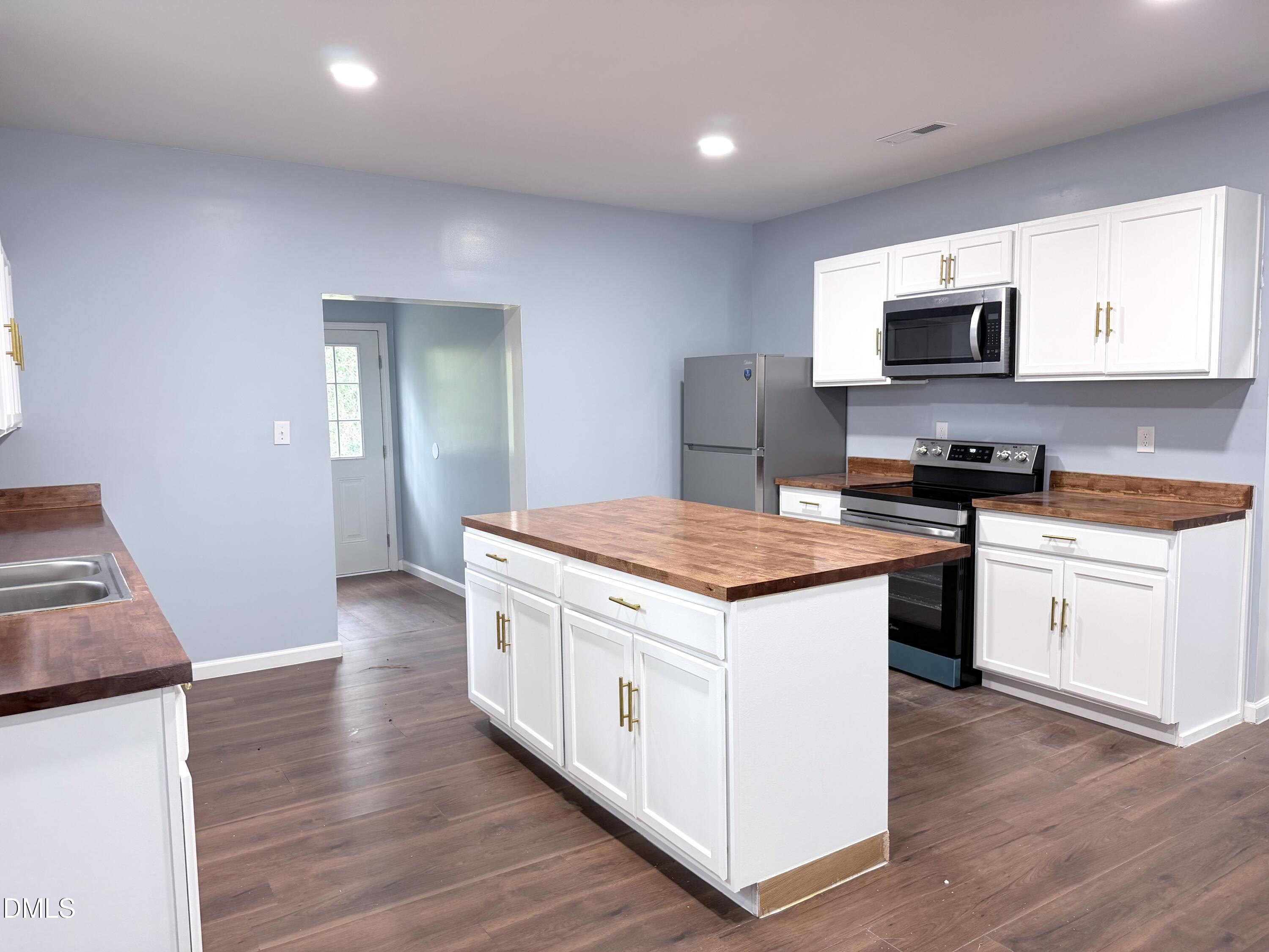4408 Lee Street Ayden, NC 28513 - Photo 3 of 17 a kitchen with a stove and a sink