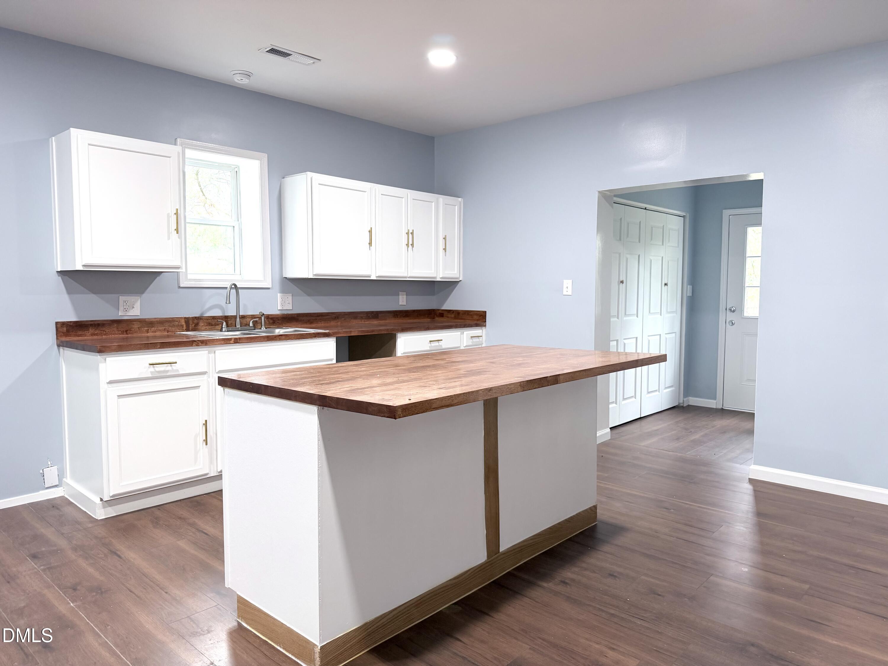 4408 Lee Street Ayden, NC 28513 - Photo 4 of 17 a kitchen with stainless steel appliances granite countertop a sink stove and wooden floor