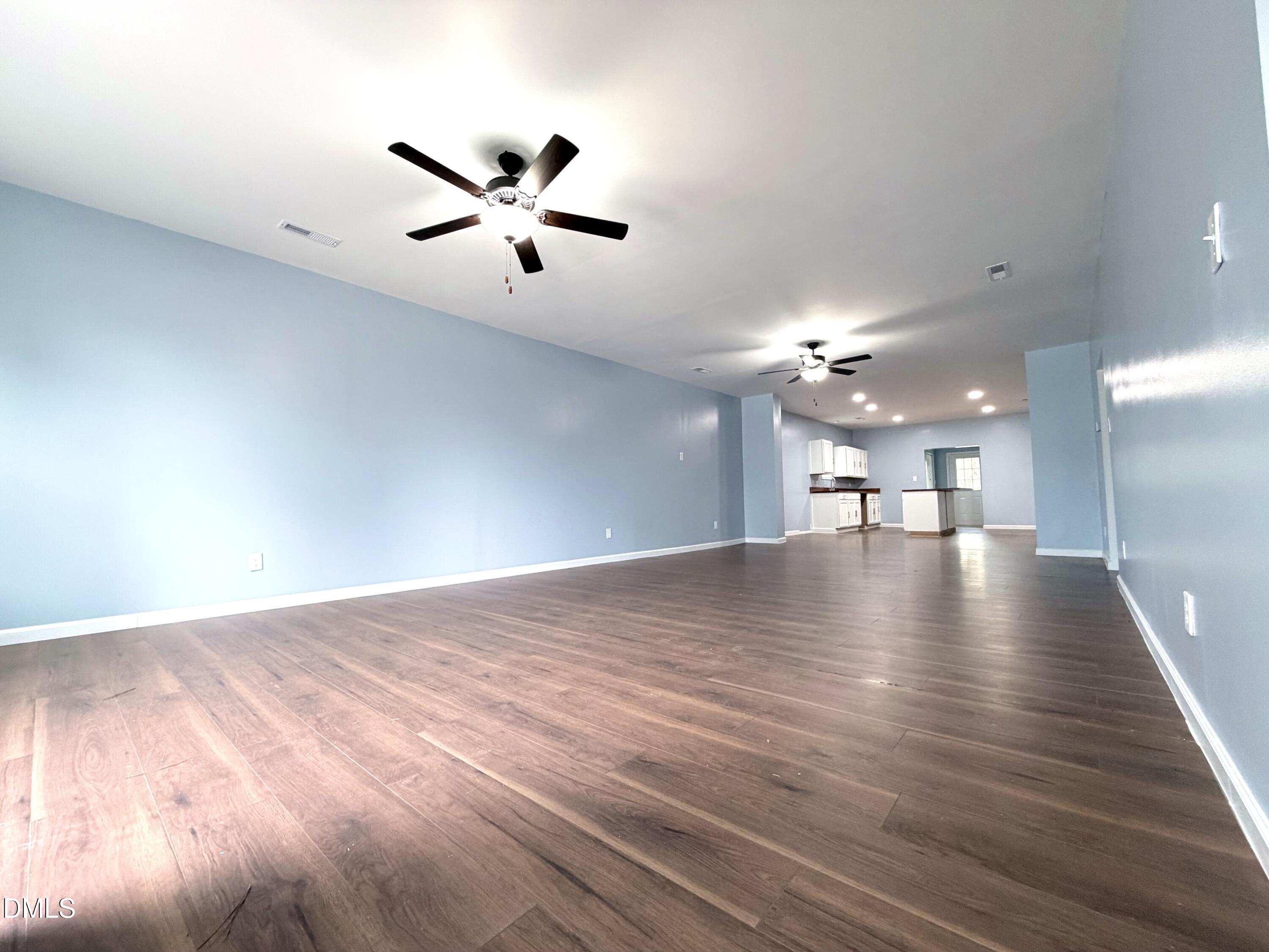 4408 Lee Street Ayden, NC 28513 - Photo 6 of 17 a view of a livingroom with a ceiling fan and wooden floor
