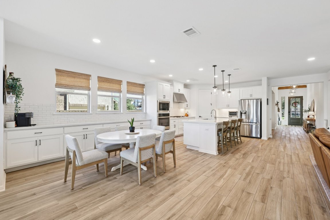 2913 Fallcrest Bend Leander, TX 78641 - Photo 12 of 40 a kitchen with a table and chairs in it