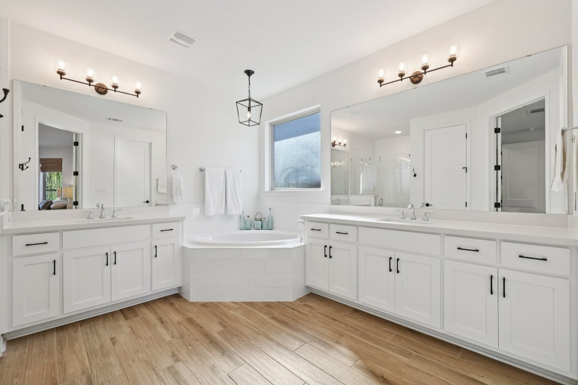 2913 Fallcrest Bend Leander, TX 78641 - Photo 16 of 40 a spacious bathroom with 2 sink tub and a mirror
