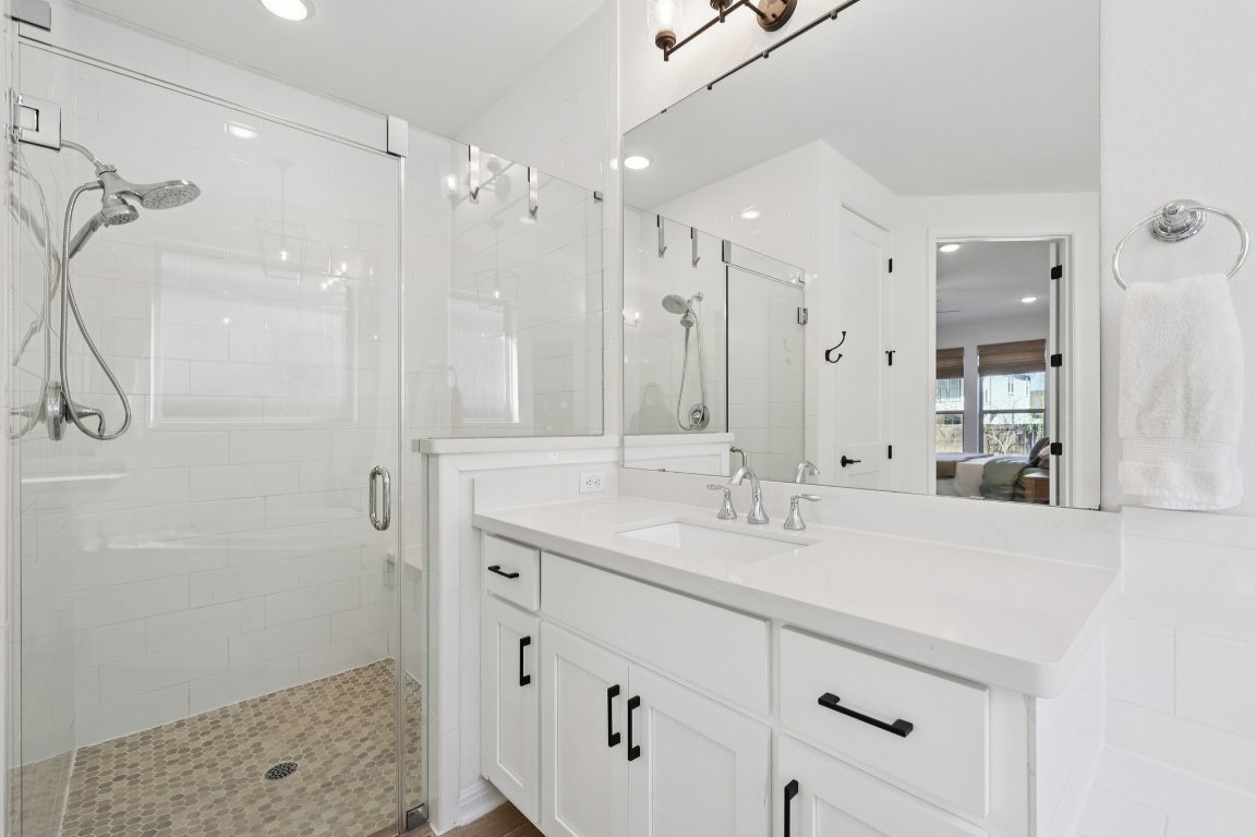 2913 Fallcrest Bend Leander, TX 78641 - Photo 17 of 40 a bathroom with a sink double vanity and shower